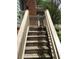 Exterior stairway with railing leading to a blue house with brick facade at 1186 Ridenour Blvd # 5, Kennesaw, GA 30152