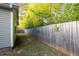 Home exterior featuring an expansive grassy yard and a wooden fence at 191 Misty Ridge Trl, Stockbridge, GA 30281