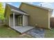 Backyard features a cozy covered patio, french doors, and green space at 191 Misty Ridge Trl, Stockbridge, GA 30281