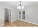Cozy dining area with hardwood floors, a stylish chandelier, and french doors leading to the backyard at 191 Misty Ridge Trl, Stockbridge, GA 30281