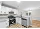 Modern kitchen boasting granite countertops, new stainless steel appliances, and bright white cabinetry at 191 Misty Ridge Trl, Stockbridge, GA 30281