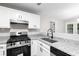 Recently renovated kitchen with granite countertops, stainless steel appliances, and white cabinets at 191 Misty Ridge Trl, Stockbridge, GA 30281