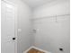 A compact laundry room with white door and connections for laundry appliances at 191 Misty Ridge Trl, Stockbridge, GA 30281