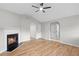 Bright living room with vaulted ceilings, a ceiling fan, a cozy fireplace, and wood flooring at 191 Misty Ridge Trl, Stockbridge, GA 30281