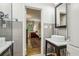 Modern bathroom with white vessel sink, gray tile, and doorway view to the bedroom at 3311 Stillhouse Se Rd, Atlanta, GA 30339