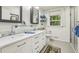 Bright bathroom featuring double sinks, marble countertops, and a glass-enclosed shower at 3311 Stillhouse Se Rd, Atlanta, GA 30339