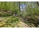 Private creek with a small shed located in a lush, wooded area creating a tranquil and secluded setting at 3311 Stillhouse Se Rd, Atlanta, GA 30339