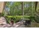 Relaxing outdoor deck with seating area surrounded by lush trees and greenery at 3311 Stillhouse Se Rd, Atlanta, GA 30339