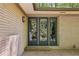 Exterior doors with glass panels offering a view of the landscaped backyard, enhancing the home's connection with nature at 3311 Stillhouse Se Rd, Atlanta, GA 30339