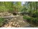 Long driveway leading to home with portico, complemented by lush landscaping and mature trees at 3311 Stillhouse Se Rd, Atlanta, GA 30339