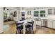Bright kitchen features custom cabinets, stainless steel appliances, center island with seating, and hardwood floors at 3311 Stillhouse Se Rd, Atlanta, GA 30339