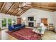 Cozy living room featuring a fireplace, exposed wood beams, and ample natural light, creating a warm and inviting space at 3311 Stillhouse Se Rd, Atlanta, GA 30339