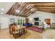 Spacious living room with a beamed ceiling, fireplace, and ample seating, ideal for entertaining or relaxing at 3311 Stillhouse Se Rd, Atlanta, GA 30339