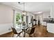 Cozy dining area with modern lighting and stainless steel appliances at 385 Russell Ridge Dr, Lawrenceville, GA 30043