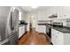 Well-equipped kitchen featuring white cabinets, dark counters, and stainless steel appliances at 385 Russell Ridge Dr, Lawrenceville, GA 30043