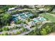 Aerial view of the community amenities featuring tennis courts, a swimming pool, clubhouse and mature trees at 5424 Landsdowne Ct, Cumming, GA 30041