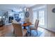 Charming dining area with wood floors and stylish lighting fixture, next to the door leading to the patio at 5424 Landsdowne Ct, Cumming, GA 30041