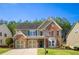 Charming two-story home with brick and siding exterior, well-manicured lawn, and a two-car garage at 5424 Landsdowne Ct, Cumming, GA 30041