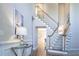 Bright foyer with hardwood floors, staircase, and elegant decor at 5424 Landsdowne Ct, Cumming, GA 30041