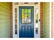 A welcoming front door with sidelights and transom window, set in a brick and siding facade at 5424 Landsdowne Ct, Cumming, GA 30041