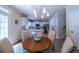 Bright kitchen and dining nook with stainless appliances, bar stool seating, and modern fixtures at 5424 Landsdowne Ct, Cumming, GA 30041