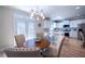Open kitchen with dining area featuring modern lighting and backyard view at 5424 Landsdowne Ct, Cumming, GA 30041