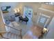 Elegant living room featuring a grand piano, bright windows, and hardwood entry at 5424 Landsdowne Ct, Cumming, GA 30041