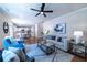 Bright and open living room with hardwood floors, ceiling fan, and views into the modern kitchen at 5424 Landsdowne Ct, Cumming, GA 30041