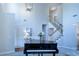 Bright living room with soaring ceilings, a piano, stylish seating, and a view of the staircase at 5424 Landsdowne Ct, Cumming, GA 30041