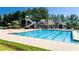 Enjoy the community pool with slide, chairs and clubhouse in a beautiful outdoor setting at 5424 Landsdowne Ct, Cumming, GA 30041
