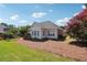 Spacious backyard with manicured lawn, mature landscaping, and a charming covered deck at 5832 Sloane St, Douglasville, GA 30135