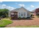 Well-maintained backyard featuring a covered deck, lush landscaping, and mature trees at 5832 Sloane St, Douglasville, GA 30135
