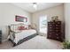 Light-filled bedroom with a cozy daybed, dresser, ceiling fan and window with white shutters at 5832 Sloane St, Douglasville, GA 30135