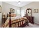 Cozy bedroom featuring two windows, a ceiling fan, and a dark wood dresser and bed frame at 5832 Sloane St, Douglasville, GA 30135