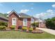 A well-maintained brick home with neatly manicured landscaping and a concrete driveway at 5832 Sloane St, Douglasville, GA 30135