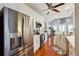 An open concept kitchen design boasts stainless steel appliances, white cabinets, and hardwood floors at 5832 Sloane St, Douglasville, GA 30135
