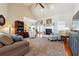 Spacious living room featuring a cozy fireplace, ceiling fan, and neutral furniture at 5832 Sloane St, Douglasville, GA 30135