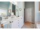 Large bathroom with dual sinks, spacious vanity with natural light, and neutral-colored walls at 5832 Sloane St, Douglasville, GA 30135