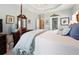 Airy main bedroom with four-poster bed, tray ceiling, neutral walls and lots of natural light at 5832 Sloane St, Douglasville, GA 30135