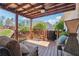 Relaxing covered porch with comfortable seating area, wood deck, and lush backyard views at 5832 Sloane St, Douglasville, GA 30135