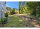 Large backyard featuring mature trees, a lush lawn, and a wood fence at 3423 Rugby Cir, Atlanta, GA 30337