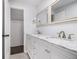 Bathroom features a white dual sink vanity with marble countertops, chrome fixtures, and modern lighting at 3423 Rugby Cir, Atlanta, GA 30337