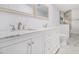 Bathroom showcasing a dual sink vanity with marble countertops, modern faucets, and ample storage at 3423 Rugby Cir, Atlanta, GA 30337