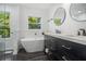 Modern bathroom featuring a soaking tub, double vanity and neutral walls at 3423 Rugby Cir, Atlanta, GA 30337