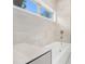 Bathroom boasts light tile, modern fixtures, and a window providing natural light above the soaking tub at 3423 Rugby Cir, Atlanta, GA 30337