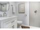 Stylish bathroom featuring modern vanity, round mirror, and glass-enclosed shower with tile surround at 3423 Rugby Cir, Atlanta, GA 30337