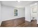 Bright bedroom with hardwood floors, large window, and ensuite bathroom with white vanity at 3423 Rugby Cir, Atlanta, GA 30337