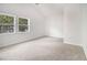 Bedroom with vaulted ceiling features neutral carpet, fresh white walls, and natural light at 3423 Rugby Cir, Atlanta, GA 30337