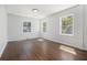Sun-filled bedroom features hardwood floors and multiple windows for natural light at 3423 Rugby Cir, Atlanta, GA 30337