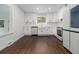Updated kitchen with white cabinetry, stainless steel appliances, and hardwood floors at 3423 Rugby Cir, Atlanta, GA 30337
